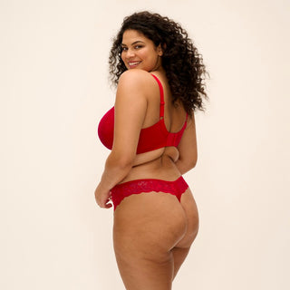 Model wearing Elomi Brianna plunge bra in Haute Red with matching thong, back view