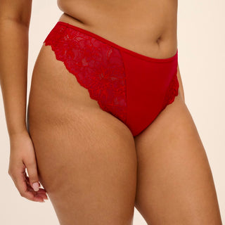 Model wearing Elomi Brianna thong in Haute Red, close-up front view