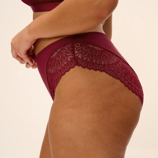 Model wearing Elomi Tiernie brief in Tibetan Red, back view