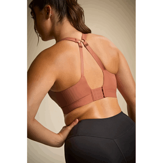 Model wearing Panache Endurance non padded underwired sports bra in Sienna Rose with racerback straps, back view