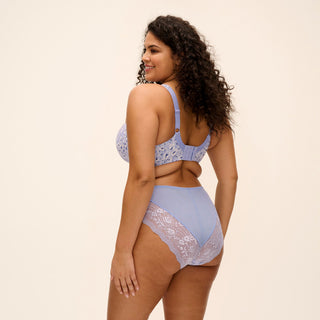 Model wearing Elomi Morgan side support banded bra and high leg brief in Blue Leopard, back view